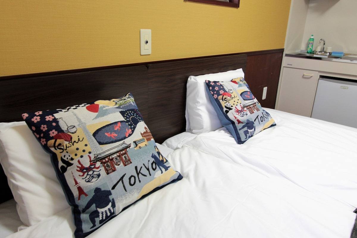 Beds with printed cushions in the Studio Twin